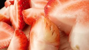 A macro video, a group of half strawberries takes center stage. With a captivating probe lens, their vibrant colors and intricate seed patterns come to life, revealing the enticing juiciness within.
