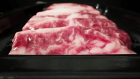 Unveiling the essence of frozen dry-aged beef, sealed in a vacuum pack, through a captivating macro video. The intricate marbling and delicate patterns. Meat concept. Beef background. 4K HDR
