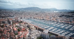 Aerial view of Marseille France, historic harbor used today as large marina, many yachts and boats. Landscape panorama of Europe from above