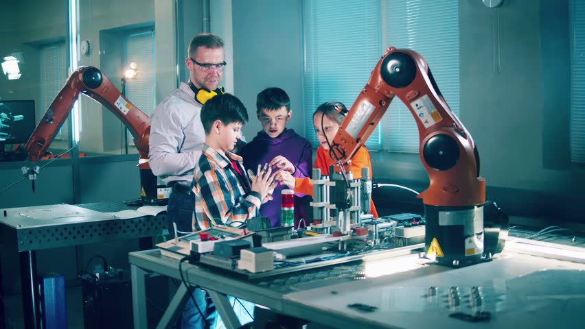 Kids and teacher observing robotic devices. Modern education concept. - Powered by Shutterstock - Get 15% off with code: PIKWIZARD15