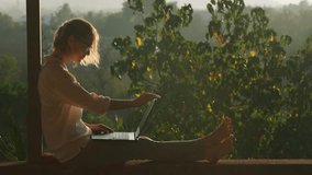 Pretty blonde woman using laptop while sitting on the rooftop in sunlight. Remotely working concept. - Powered by Shutterstock - Get 15% off with code: PIKWIZARD15