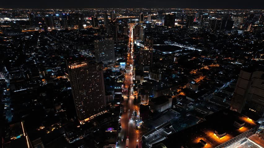 Night city drone time lapse compilation Bangkok, Thailand.
Flying along the highway road with moving traffic with DJI Mavic. Modern skyscrapers, buldings, blocks around, hyperlapse, abstract, lights
