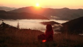 Charming young woman breathing calmly meditating on the top of mountains landscape Relaxed girl closing eyes practicing yoga on nature with golden sunset - Powered by Shutterstock - Get 15% off with code: PIKWIZARD15