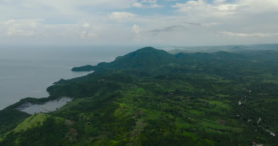 Tropical mountain with green forest and agricultural land in countryside. Mindanao, Philippines.