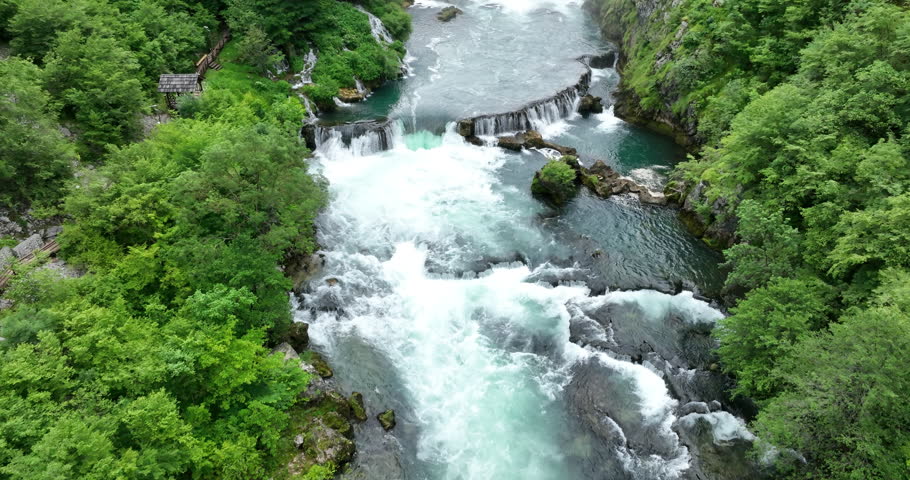 aerial shot of wild river with huge waterfall