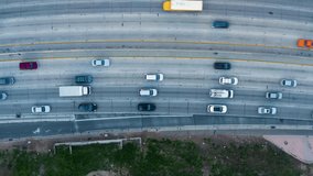 Direct view from above to the road traffic. Traffic jam at a highway junction. Aerial Drone Flight top down View of freeway busy city rush hour heavy traffic jam highway. Vertical video. 
