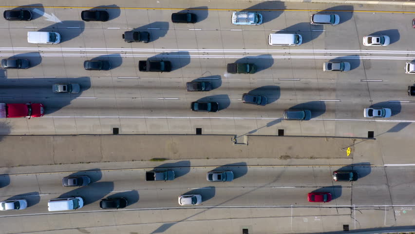 Direct view from above to the road traffic. Traffic jam at a highway junction. Aerial Drone Flight top down View of freeway busy city rush hour heavy traffic jam highway. Vertical video. 