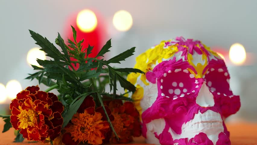 Pink and yellow skull with orange marigolds on the table. Day of the Dead is a traditional carnival. Happy Day of the Dead background. Happy Halloween background. Royalty-Free Stock Footage #1106511813