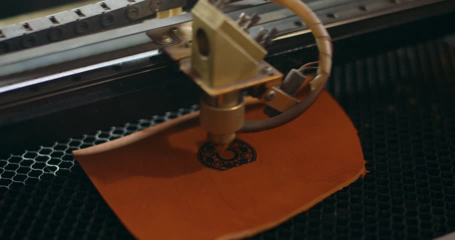Laser makes engraving on leather wallet , art. slow motion. laser engraver machine working process. decoration of leather accessories, items, close up shot Royalty-Free Stock Footage #1106512045