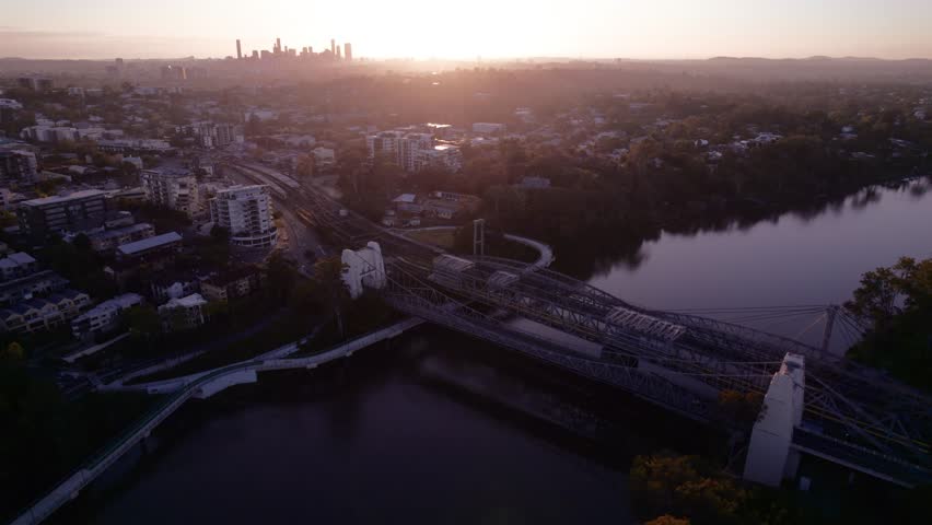 Sunrise over Indooroopilly, Brisbane River in the foreground and Brisbane CBD in the backround. Queensland, Australia