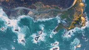 Road along the coast drone view. Travel by car. The sea coast and the road.USA, Monterey, California. Aerial view of a road running between a mountain and the ocean waves. Vertical video. 
