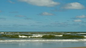 Slow motion video clip of waves at the beach on a sunny day. Shot at Zandvoort in the Netherlands.