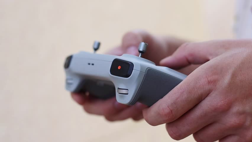 Drone remote control settings screen hands close up