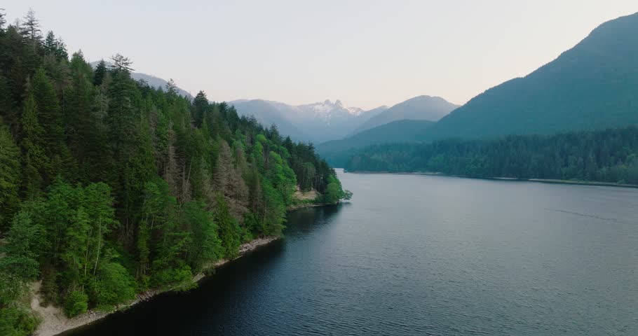 Aerial drone view over picturesque Capilano Lake in North Vancouver, Canada. Royalty-Free Stock Footage #1106533795