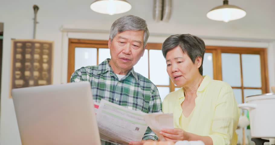 Close up view of asian elderly couple reading bills worrying in the kitchen - overspending bills make and without financial planning make their retirement life unhappy Royalty-Free Stock Footage #1106536195