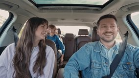 Family, transport, safety, road trip and people concept. Happy man and woman with little child driving in car. Auto tourism. Safety riding car concept wide angle inside car view image. - Powered by Shutterstock - Get 15% off with code: PIKWIZARD15