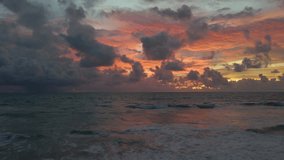 Wave hit beach smooth colorful clouds at sunset evening sky over sea wave Amazing nature video background Stunning clouds and sky in Golden hour Time