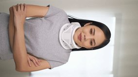 
Vertical shots of portrait happy woman recovery from accident fracture wearing neck splints collar smiling by mobile video call chat application or social media. Webcam view, vertical video concept.