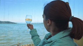 Woman tasting white wine, Waving wine in the wineglass. 4k footage UHD 3840x2160 