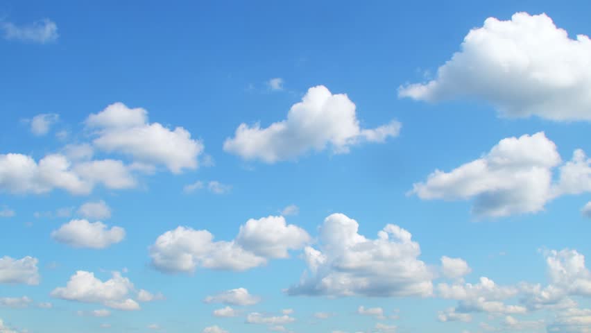 Blue sky with slowly moving white clouds. Calm, relaxing background.