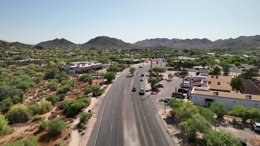 Drone shot of cars driving through Arizona's town of Cave Creek. Royalty-Free Stock Footage #1106547247