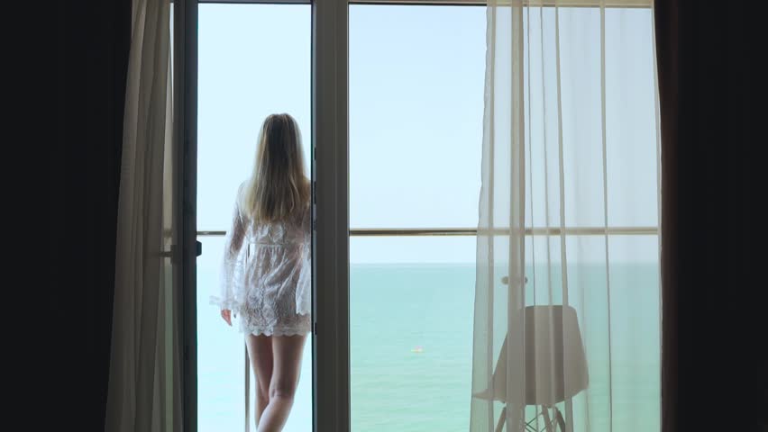Vacation Female Steps Out On The Balcony And Admires The Beautiful Ocean View On A Sunny Summer Day. Travel, Summer Holidays, Tourism. Royalty-Free Stock Footage #1106547793