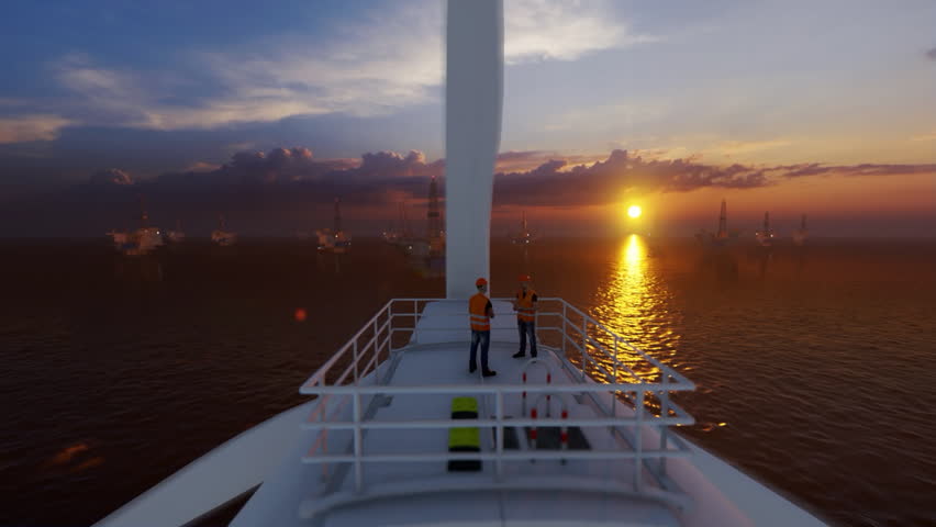 Maintenance worker on top of a offshore wind turbine with oil rigs against sunset