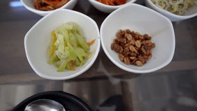 Korean food side dishes Banchan multiple small portions top view angle video kimchi bean sprouts vegetable