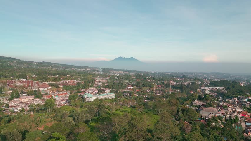 Deforestation. Aerial view of Indonesian forests that are used as housing by humans with Mount Salak in the background. Global warming, climate change, ecology