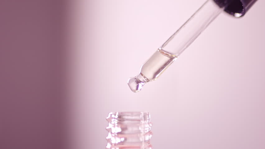 Liquid fluid oil or serum essential in pipette drips on pink background. Cosmetic skin care product, beauty concept. Royalty-Free Stock Footage #1106551273