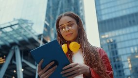Young alternative multiethnic woman spending time in a modern part of the city. Female programmer going to work in the office - Powered by Shutterstock - Get 15% off with code: PIKWIZARD15