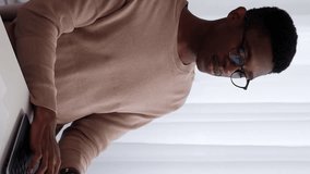 Vertical video. Computer work. Online chatting. Focused smiling business man employee typing on laptop browsing for project at workplace desktop. - Powered by Shutterstock - Get 15% off with code: PIKWIZARD15