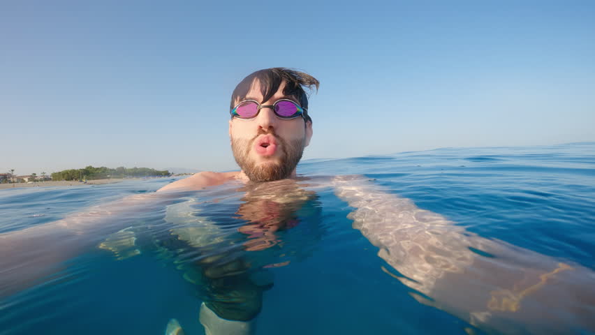 Swimmer breath fresh air after aerobics workout in ocean water