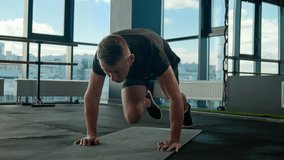 Active sportsman Caucasian athletic man guy male sport trainer bodybuilder workout in running plank mountain climber exercise on mat lifting legs bend knees loss weight cardio training in fitness gym - Powered by Shutterstock - Get 15% off with code: PIKWIZARD15