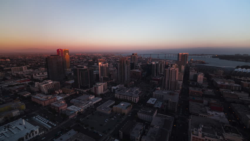 Establishing Aerial View Shot of San Diego CA, California, United States of America, downtown, sunset sunrise, track back reveal, Gaslamp Quarter, East Village, Coronado Bridge, port of San Diego