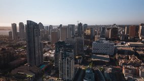 Establishing Aerial View Shot of San Diego CA, California, United States of America, downtown, strong sun, flying between skyscrapers, track circle right