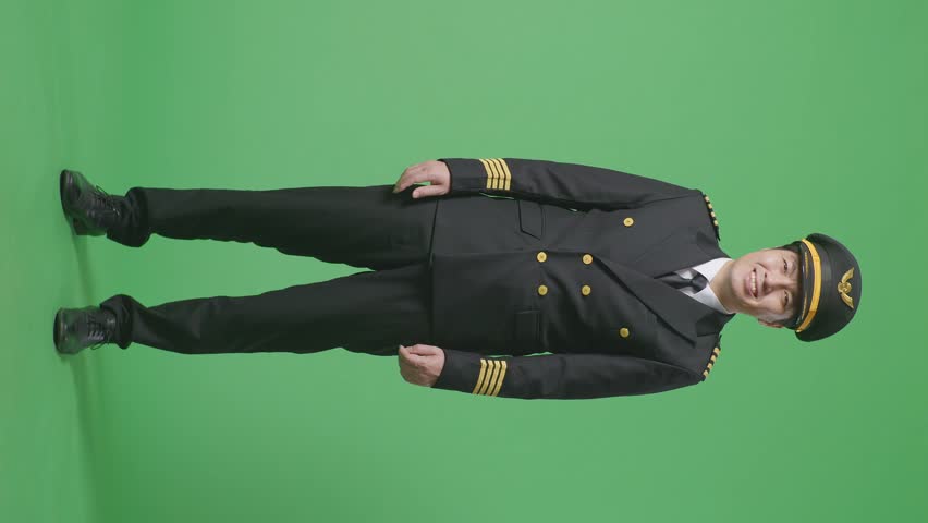 Full Body Of Asian Man Pilot Standing And Smiling To Camera In The Green Screen Background Studio
