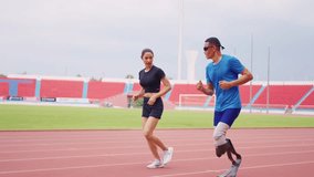 Asian athlete with prosthetic blades and trainer workout in stadium. Attractive amputee male runner and young sportswoman feel happy and enjoy practicing workout for Paralympics running competition. - Powered by Shutterstock - Get 15% off with code: PIKWIZARD15