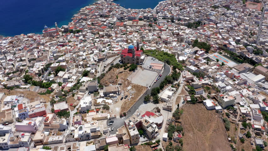 Aerial: Flying over Ermoupoli city of Syros island, Greece on a sunny day