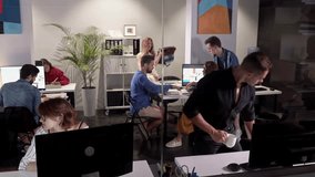 Wide Angle View Of Busy Design Office With Workers At Desks. Team job. Young businessmans crew working with new startup project in modern loft. Design Team Planning for a New Project. Team of young - Powered by Shutterstock - Get 15% off with code: PIKWIZARD15