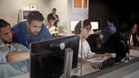 Coworkers looking at a computer and talking about work. Team of colleagues brainstorming together while working on the computer. Men colleagues discuss online project look at pc screen - Powered by Shutterstock - Get 15% off with code: PIKWIZARD15