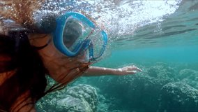 Underwater of a woman snorkeling above a coral reef. Girl in snorkeling mask dive underwater with tropical fishes in coral reef sea pool. Travel lifestyle, water sport outdoor adventure, swimming - Powered by Shutterstock - Get 15% off with code: PIKWIZARD15