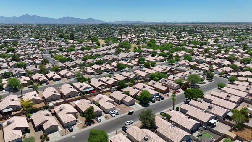 New housing development in southwest USA. Aerial descending shot in neighborhood of stucco houses. Population boom in the southern United States.