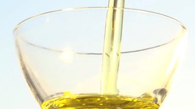 Olive oil poured into a glass bowl. Slow motion 240 fps. High speed camera shot. Full HD 1080p. Slowmo