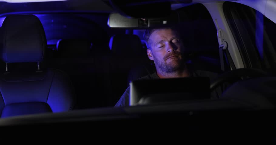 sad angry man sitting inside a car after stopped by police on the road at night Royalty-Free Stock Footage #1106579907