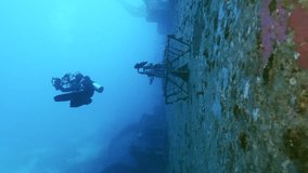 Scuba diver cameraman filming deck of ferry Salem Express shipwreck, Slow motion