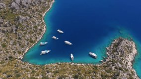 Flying over of excursion boats take a swimming break in Aquarium Bay in Kekova. A bay with turquoise water and motorboats on blue sea in summer. Antalya, Turkey
 - Powered by Shutterstock - Get 15% off with code: PIKWIZARD15