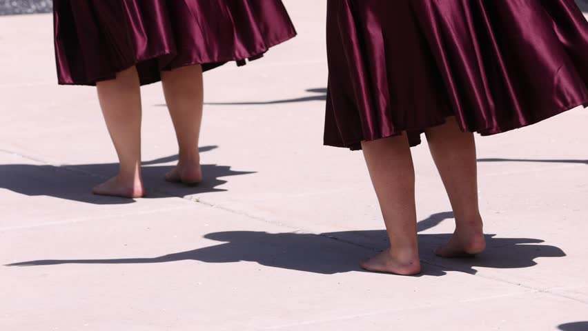 Synchronized hula dance steps with bare feet and shadows showing arm movements Royalty-Free Stock Footage #1106584859