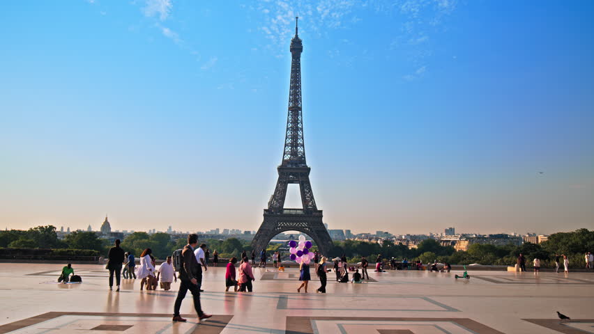 Views of the Tower from Trocadero in Paris, France. Tourists enjoy historical landmark and symbol of Paris taking pictures and celebrating with balloons at sunrise in Paris. Royalty-Free Stock Footage #1106591631