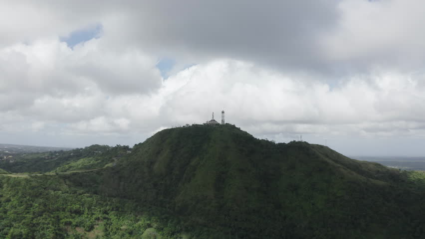 Cinematic aerial footage of a tower on a rainforest hill close to Cebu in the Philippines, Asia, Drone